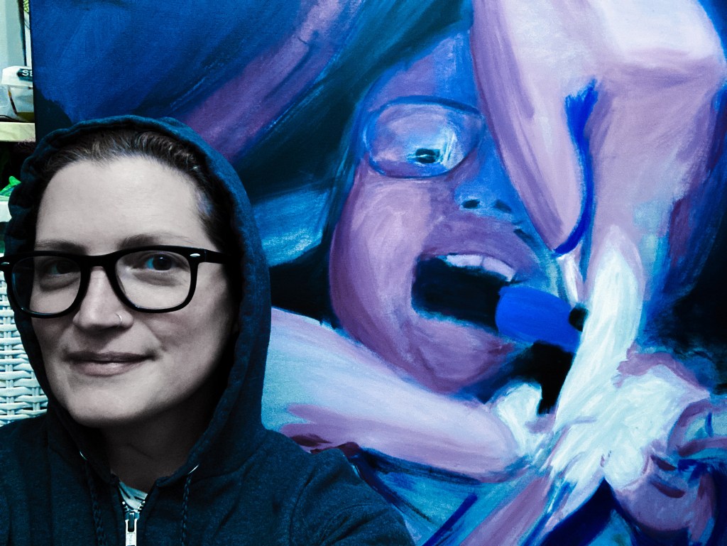 Tanja Hester in front of in-progress painting from the "No Anesthesia" series